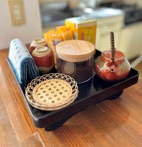 a tray with various food items on a table at 眠りの癒201 I Cozy Apt, 3min Beach, Bus, Train, Onsen, Izakaya, WiFi in Beppu