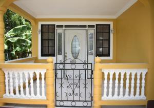 a front door of a home with a white at Villa Cherry in Gros Islet
