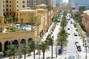 a street in a city with palm trees and buildings at Amazing views Dubai eye & Palm in Dubai