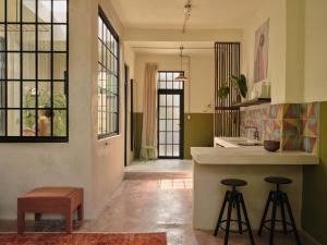 a kitchen with a counter and stools in a room at PAZ by DW in San Juan