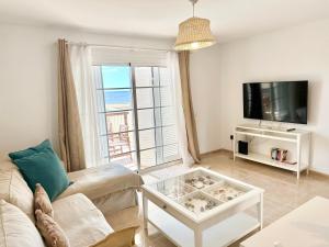 a living room with a couch and a tv at Sunny Beach Villa - El Medano in El Médano