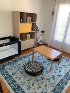 een woonkamer met een tafel en een tapijt bij Appartement T3 Anglet 67m2 in Anglet