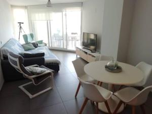 a living room with a table and a couch at Valencia Beach & Nature in La Torre