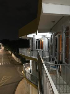a balcony of a building with chairs on it at night at Hotel Belo Jardim in Hortolândia
