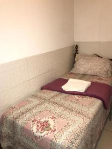 two twin beds in a room with a bedskirts at Hotel Belo Jardim in Hortolândia