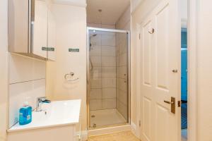 a bathroom with a shower and a sink at Westholme Lodge in Minehead