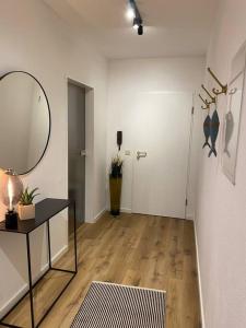 a room with a mirror and a table and a hallway at “Heimathafen“ in Bad Zwischenahn in Bad Zwischenahn