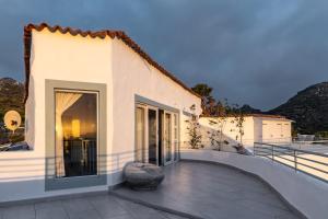 a house with a balcony with a large window at Capri Sands Luxury Guest House in Crawley