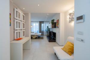 a white living room with a couch and a living room at [IHost Apartment] - Tito Livio 20 in Milan