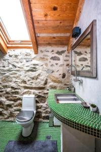 a bathroom with a toilet and a sink at Подковите in Karlovo