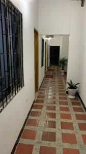 a hallway of a building with a tile floor at Habitaciones Mónaco in Coveñas