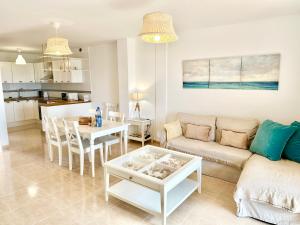 a living room with a couch and a table at Sunny Beach Villa - El Medano in El Médano +10 photos