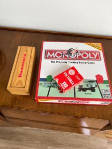 a monopoly board game and a monopolytracking board game on a table at The Old Gatehouse Luxury Cottage in Legbourne