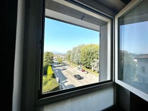 a window with a view of a street at Urban Oasis Appartamento vicinanze Como 15km in Cantù