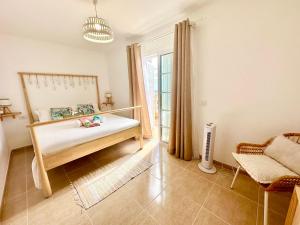 a bedroom with a bed and a window at Sunny Beach Villa - El Medano in El Médano