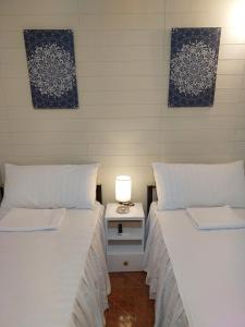 two beds sitting next to each other in a room at Apartelle near Philippine Arena in Bulakan
