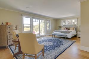 a bedroom with a bed and a table and chairs at Luxe Scituate Vacation Rental with Private Hot Tub! in Scituate