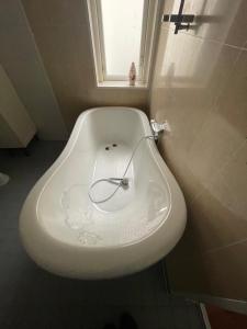 lavabo blanco en un baño con ventana en Villa LA en Landskrona