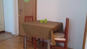 een tafel met twee groene kopjes erop bij Studio Apartment Lenka in Milna