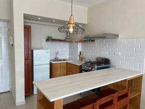 a kitchen with a counter top and a refrigerator at Villa Marbella by Potenza Rentals in Santo Domingo
