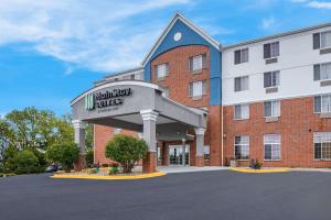 a large red brick building with a hotel at MainStay Suites Fitchburg - Madison in Madison