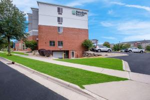 un edificio de ladrillo con un cartel en el costado en MainStay Suites Fitchburg - Madison en Madison