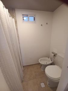 a bathroom with a toilet and a sink at Delta Home II in San Carlos de Bariloche