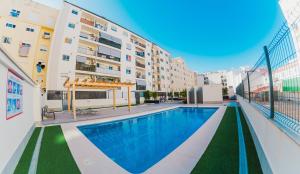 a swimming pool in the middle of a building at apartaluxdenia in Denia