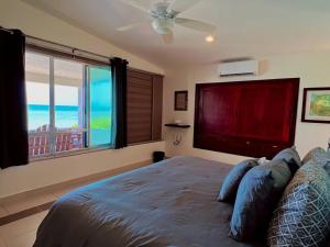 a bedroom with a bed with a view of the ocean at Beach Bliss Bungalow - Amazing pool in Chelem +7 photos