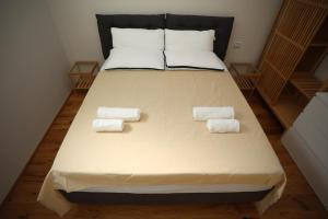 a bed with two pillows and two towels on it at Cozy Loft in charme position - Brera Moscova in Milan