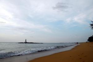 a lighthouse on an island in the ocean with a beach at Kokotel Khao Lak Seascape in Khao Lak