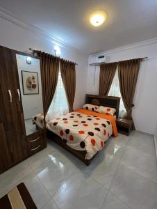 a bedroom with a bed and a mirror in it at Melford Homes in Lagos