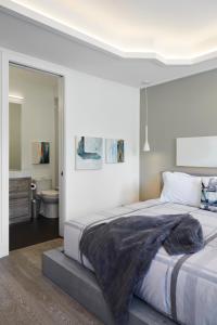a bedroom with a large bed and a bathroom at Elegant Downtown Home in Toronto