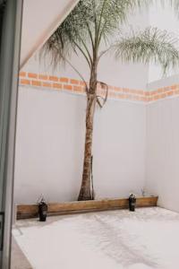 a room with a palm tree on the wall at Amplia Casa Moderna c/ Piscina y Lindos Jardines 
