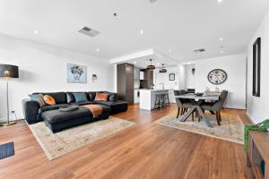a living room with a couch and a table at Belle Escapes - Beach Retreat Townhouse Glenelg in Glenelg