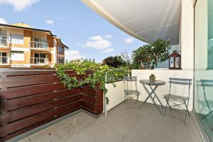 a patio with a fence and a table and chairs at Belle Escapes - Beach Retreat Townhouse Glenelg in Glenelg