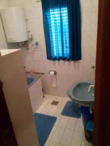 a bathroom with a green sink and a toilet at Apartments by the sea Necujam, Solta - 21776 in Grohote