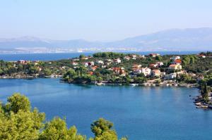 a small island in the middle of a lake at Apartments by the sea Necujam, Solta - 21776 in Grohote +17 photos