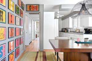 a kitchen and dining room with art on the walls at Pick from Curated Vintage Vinyl 3B-2B Lic 65597 in La Quinta