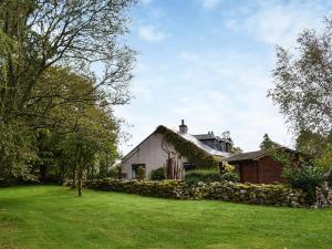 a house with a green lawn in front of it at Netherley Grange in Peterculter