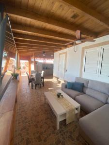 a living room with a couch and a table at Beach Villa private heated pool in Caleta De Fuste
