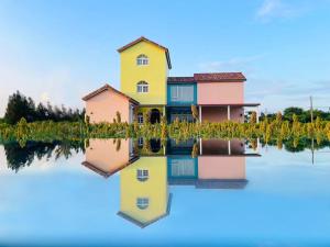 a house in the water with its reflection at Village in Jinsha