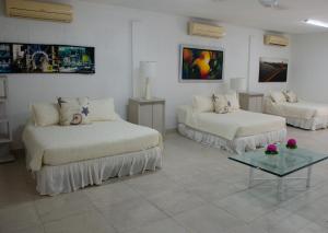מיטה או מיטות בחדר ב-CAMATAJUA BARU HOUSE