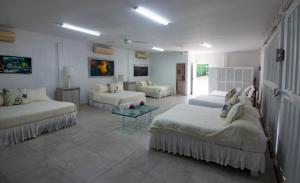 מיטה או מיטות בחדר ב-CAMATAJUA BARU HOUSE