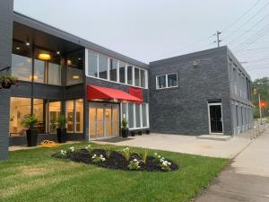 a gray building with a red awning on it at Superior Shores Hotel BW Signature Collection in Thunder Bay