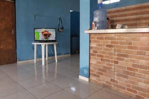a room with a table with a television on it at Quarto com ar condicionado, WiFi in Tareco