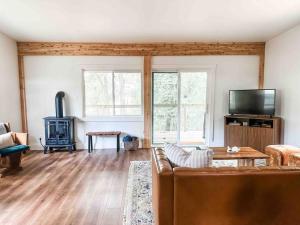 a living room with a couch and a fireplace at Lakeside Cabin - Serene Retreat with Lake Monroe Views and Wraparound Deck in Brown County in Nashville