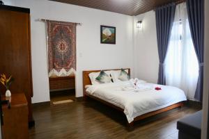 Postel nebo postele na pokoji v ubytování JE T'AIME VILLA - Khu nghỉ dưỡng nhà vườn nằm giữa thiên nhiên bao la hoa cỏ