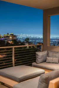 a balcony with two couches and a view of the city at 6MIL 5BR Sunset Strip Villa Jetliner Views Oasis in Los Angeles