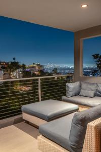 two beds on a balcony with a view of the city at 6MIL 5BR Sunset Strip Villa Jetliner Views Oasis in Los Angeles